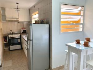 a kitchen with a refrigerator and a table in it at Departamento Céntrico Tucumán 1A in San Miguel de Tucumán