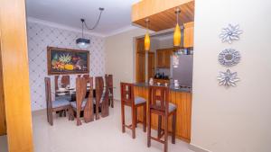 a kitchen and dining room with a table and chairs at Sky Blue in Jarabacoa