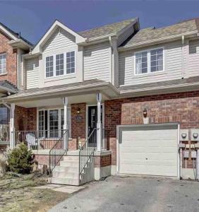a brick house with a white garage door at No available not in Welland