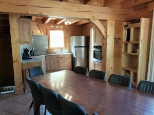 a kitchen with a large wooden table and chairs at Chalet Le Grand-Bornand, 7 pièces, 13 personnes - FR-1-467-31 in Le Grand-Bornand