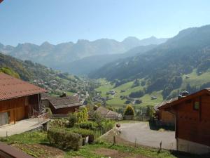 a view of a valley with houses and mountains at Appartement chalet pour 6 pers., animaux admis, parking - FR-1-467-39 in Le Grand-Bornand +3 photos