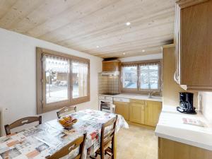 a kitchen with a table and chairs in a room at Appartement Le Grand-Bornand, 3 pièces, 6 personnes - FR-1-467-47 in Le Grand-Bornand