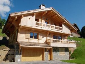 a large wooden house with a balcony on it at Chalet Le Grand-Bornand, 6 pièces, 12 personnes - FR-1-467-44 in Le Grand-Bornand