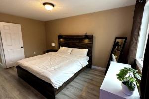 a bedroom with a large bed with white sheets at No available not in Welland