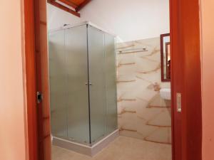 a glass shower in a bathroom with a toilet at Wilpattu Blue Sapphire lite - B&B in Wilpattu