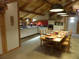 a large kitchen with a wooden table and chairs at Appartement Le Grand-Bornand, 4 pièces, 10 personnes - FR-1-467-100 in Le Grand-Bornand