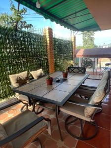 a wooden table and chairs on a patio at Departamento Sol in Manta