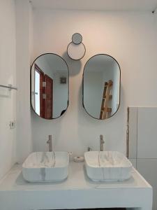 a bathroom with two sinks and two mirrors at New Appartement Fisherman in Bophut 