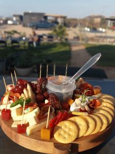 a plate of cheese and fruit on a table at VALLE LIFE in Sansoni