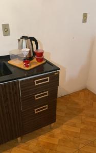 a kitchen counter with a tea kettle on top of it at Apartamento 03 br 290 restaurante Le Sorelle in Rosário do Sul