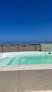 a swimming pool with a blue sky in the background at Boca de agua Villas in Nautla