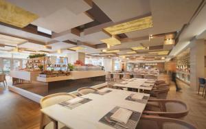 a restaurant with tables and chairs and a buffet at Sheraton Grand Shanghai Pudong Hotel & Residences in Shanghai