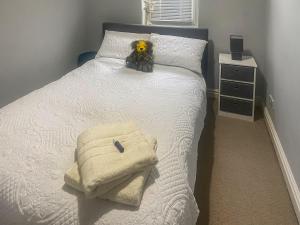 a bed with a stuffed dog sitting on top of it at Beckside Court in Brampton