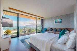 a bedroom with a large bed with a view of the ocean at Ocean Front Villa Nha Trang in Nha Trang