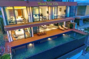 a house with a swimming pool in front of it at Ocean Front Villa Nha Trang in Nha Trang