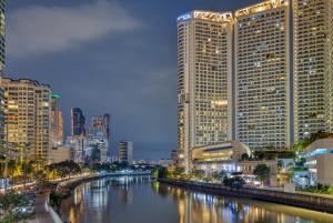 einen Fluss in einer Stadt mit hohen Gebäuden in der Unterkunft Queen Suite with City View at Acqua Private Residences in Manila