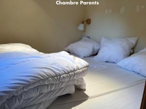 a bed with white sheets and pillows on it at Appartement Valloire, 1 pièce, 4 personnes - FR-1-263-535 in Valloire