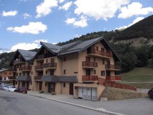 a large building with balconies on the side of a street at Appartement Valloire, 1 pièce, 4 personnes - FR-1-263-535 in Valloire