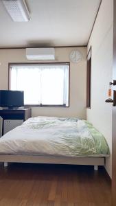 Ένα ή περισσότερα κρεβάτια σε δωμάτιο στο friendly 民宿 +13 φωτογραφίες