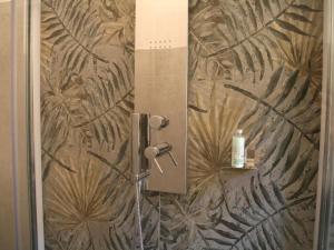 a shower in a bathroom with a wall at Roman Home Base in the Appio Latino in Rome +32 photos