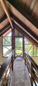 a wooden walkway in a room with windows at Eden Escape in Diwan