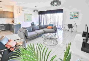 a living room with a couch and a table at Indulge Apartments - CBD in Mildura