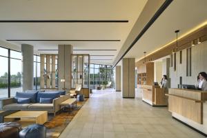 a lobby of a hospital with people sitting at desks at Fairfield by Marriott Jakarta Soekarno-Hatta Airport in Tangerang