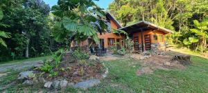 a wooden house in the middle of a yard at Eden Escape in Diwan
