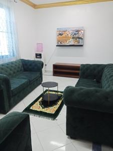 a living room with two couches and a table at Mombasa , Kenya 2 bedroom Master Ensuite in Mombasa