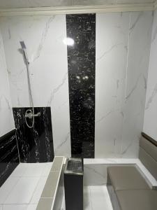 a bathroom with a black and white marble wall at Khan Hotel Ulaanbaatar in Ulaanbaatar