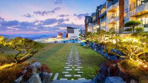 a walkway in front of a building at dusk at Ganghwa Elijah Resort in Incheon
