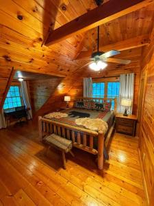 a bedroom with a bed in a log cabin at Smokey Mountain Retreat in Waynesville