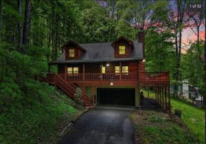 a large house with a garage in the woods at Smokey Mountain Retreat in Waynesville