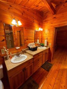 a bathroom with two sinks in a wooden cabin at Smokey Mountain Retreat in Waynesville +42 photos