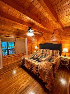 a bedroom with a bed in a wooden cabin at Smokey Mountain Retreat in Waynesville
