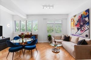 a living room with a couch and a table and chairs at Potts Point l 2 Bedroom Stylish Retreat in Sydney