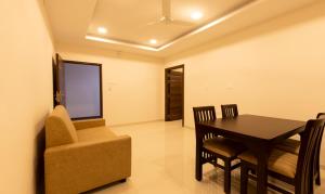 a dining room with a table and a chair at Nectar Nest in Coimbatore