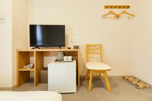 a room with a small refrigerator and a television at GATE STAY hotel Osaka Namba in Osaka