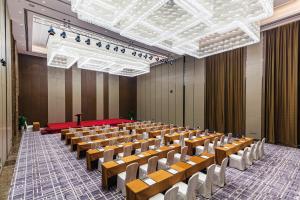 a lecture hall with rows of chairs and a podium at Wanda Realm Heshan in Jiangmen