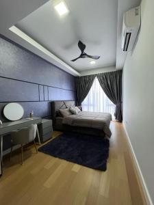 a bedroom with a bed and a desk and a window at Sentral Suites Kuala lumpur By Leyla in Kuala Lumpur