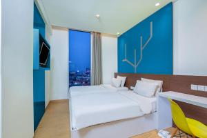 Letto o letti in una camera di 1O1 URBAN Jakarta Pemuda