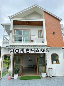 a building with a sign for a hotel at Homehana Pua in Pua
