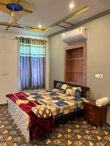 a bedroom with a bed and a air conditioner at The Mehran way Homestay in Jodhpur