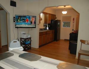 a living room with a flat screen tv on the wall at The Young’s - Northern Indiana in Gary