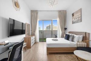 a hotel room with a bed and a large window at Perfect Getaway Studio APT Aura by Aziza in Dubai