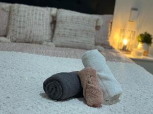 a towel on a bed with a stuffed animal on it at Eden Lodge in Auckland
