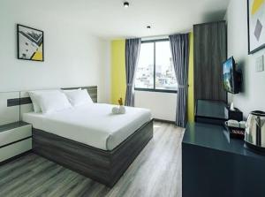 a hotel room with a bed and a television at AILEN BOUTIQUE HOTEL in Ho Chi Minh City