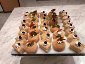 a bunch of appetizers on a plate on a table at Guangzhou Baiyun Airport COCO Hotel T2 Terminal Store Canton Fair Free Shuttle Bus in Huadu
