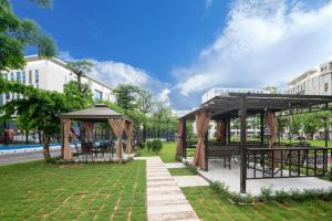 a pavilion with tables and benches in a park at Guangzhou Baiyun Airport COCO Hotel T2 Terminal Store Canton Fair Free Shuttle Bus in Huadu
