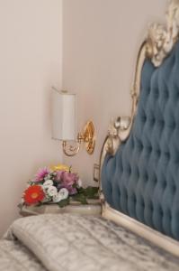 ein Schlafzimmer mit einem Bett und einem Tisch mit Blumen in der Unterkunft Hotel Villa Serena in Marghera